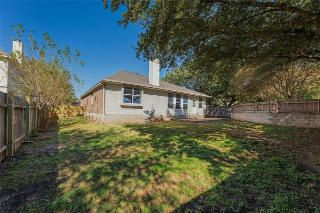 back of house with a lawn