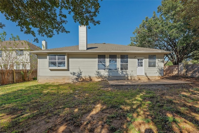 back of house featuring a yard