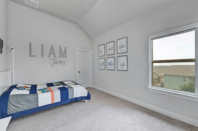 carpeted bedroom featuring lofted ceiling