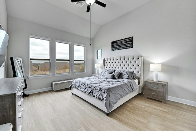 bedroom featuring ceiling fan, light hardwood / wood-style floors, and lofted ceiling