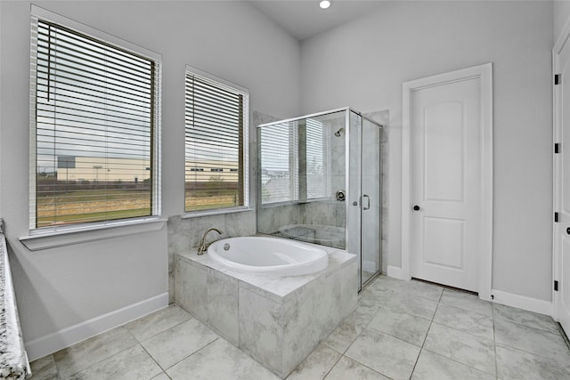 bathroom featuring plus walk in shower and tile patterned floors