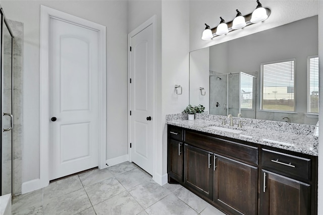 bathroom with vanity, tile patterned flooring, and a shower with shower door