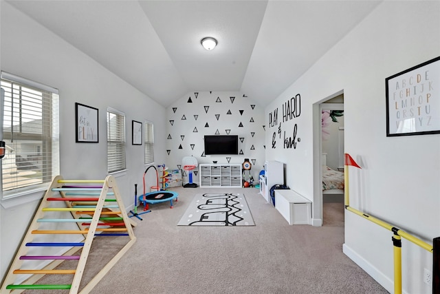 recreation room with lofted ceiling and carpet floors