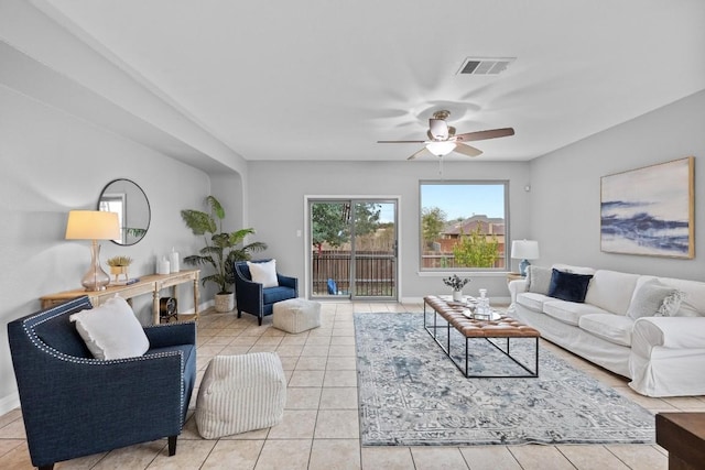 living room with light tile patterned floors, baseboards, and visible vents