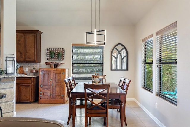 dining space featuring light tile patterned floors