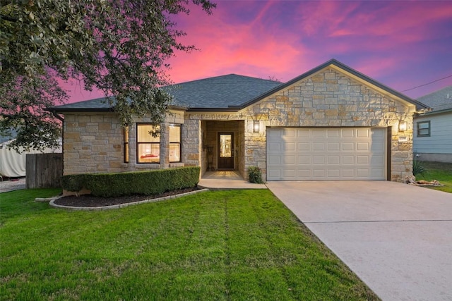 ranch-style home with a lawn and a garage