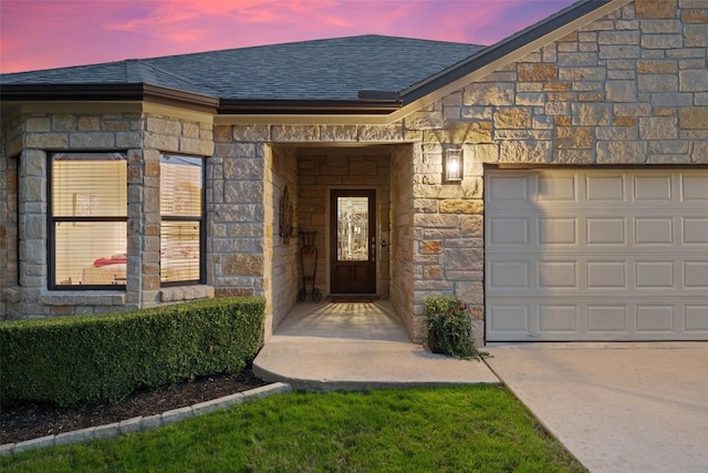 exterior entry at dusk with a garage