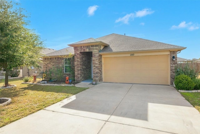 view of front of property featuring a front lawn and a garage