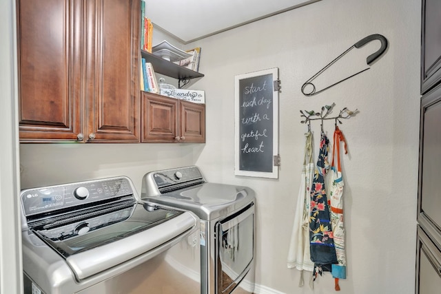 clothes washing area featuring cabinets and separate washer and dryer