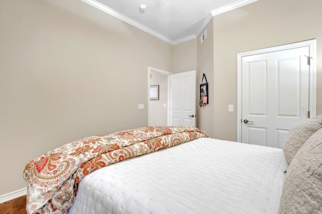 bedroom featuring wood-type flooring and ornamental molding