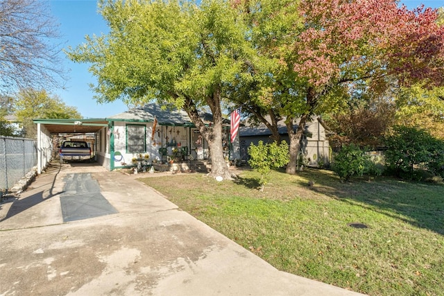 view of front facade featuring a front yard and a carport