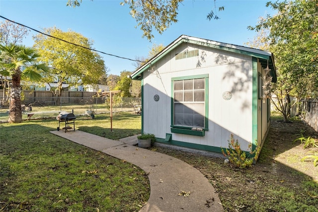 view of outbuilding featuring a yard