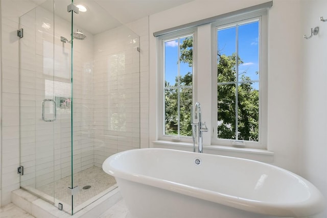 bathroom featuring sink, plenty of natural light, and shower with separate bathtub