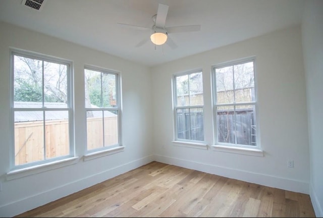 unfurnished room with ceiling fan and light wood-type flooring