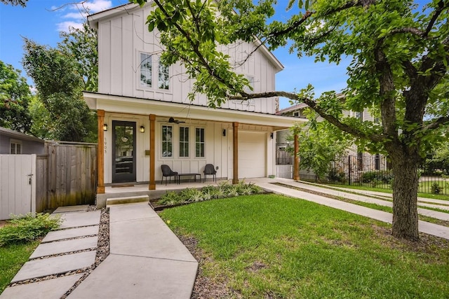 view of front facade featuring a porch, a garage, and a front lawn