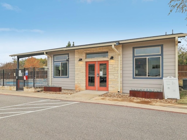 view of front of home with french doors and central AC