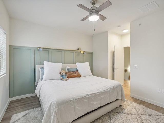 bedroom featuring light wood-type flooring and ceiling fan