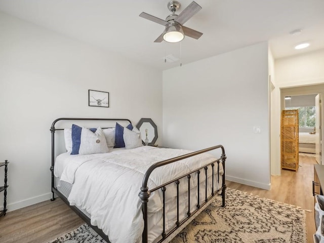 bedroom featuring ceiling fan and light hardwood / wood-style flooring