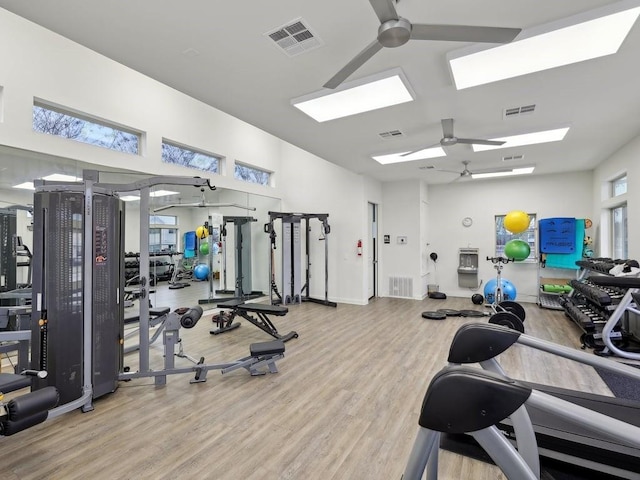 workout area with ceiling fan and wood-type flooring