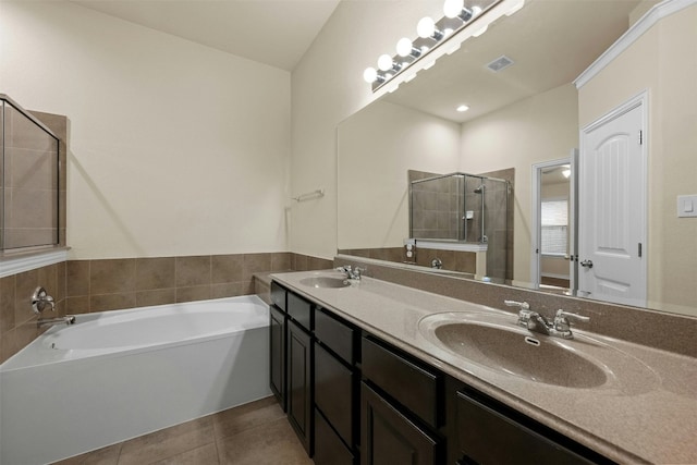 bathroom with tile patterned flooring, vanity, and plus walk in shower