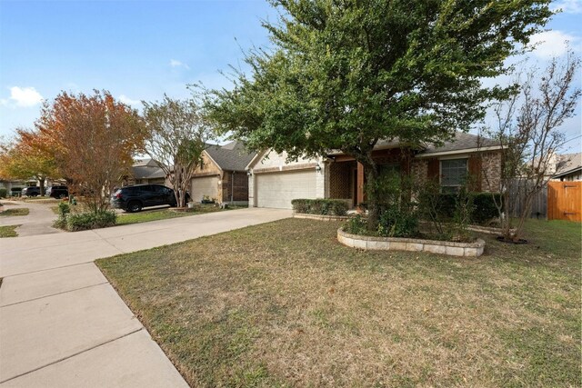 ranch-style home with a front yard and a garage