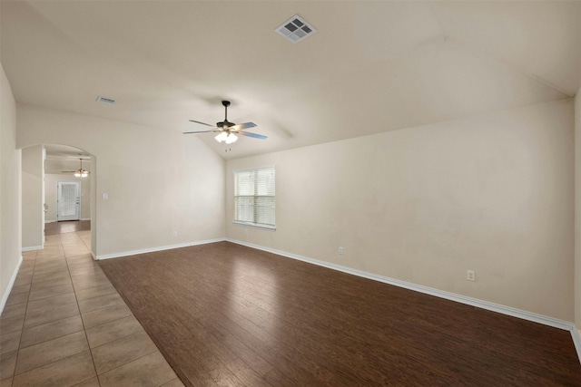 empty room with wood-type flooring, vaulted ceiling, and ceiling fan