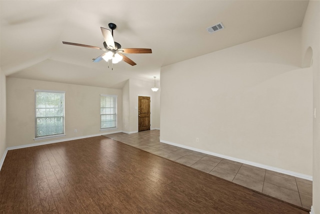 spare room with ceiling fan, lofted ceiling, and light hardwood / wood-style flooring