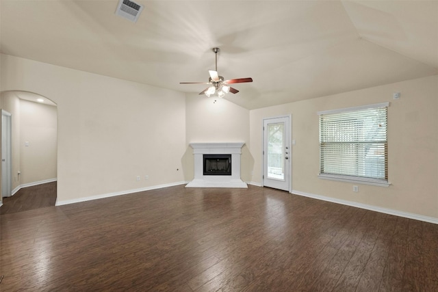 unfurnished living room with vaulted ceiling, dark hardwood / wood-style floors, and ceiling fan