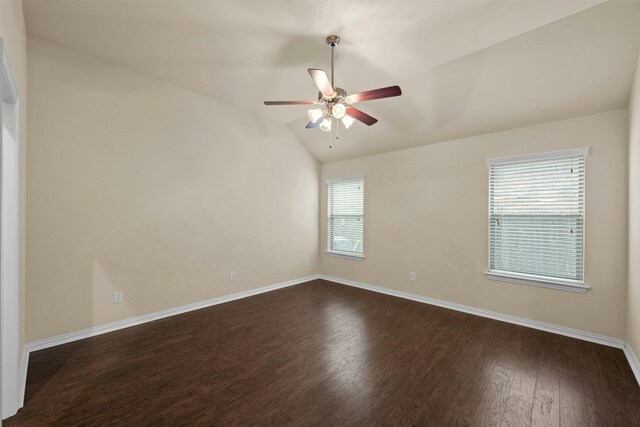 spare room featuring dark hardwood / wood-style flooring, vaulted ceiling, and ceiling fan