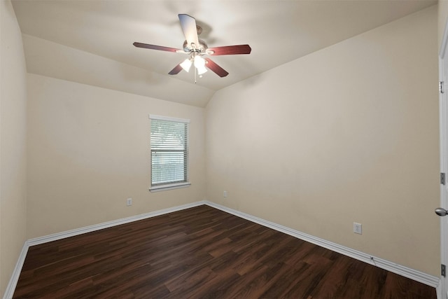 empty room with vaulted ceiling, dark hardwood / wood-style floors, and ceiling fan