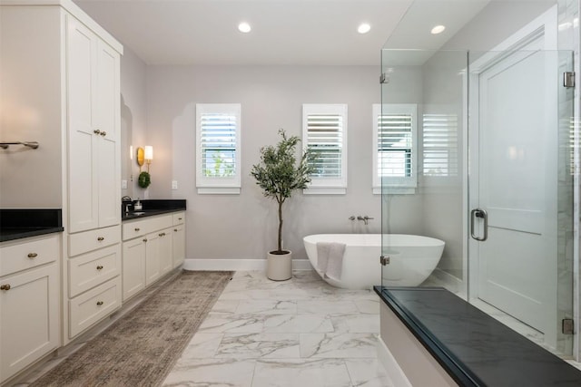 bathroom featuring plus walk in shower and vanity