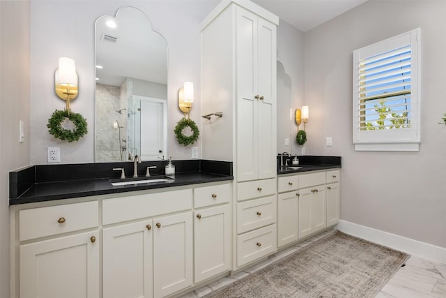 bathroom featuring vanity and a shower with door