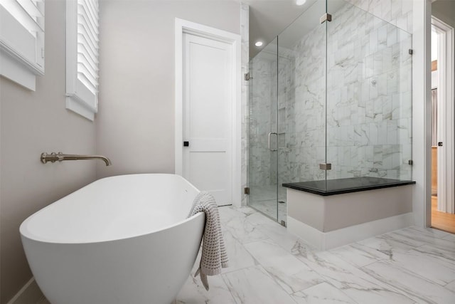 bathroom featuring a wealth of natural light and shower with separate bathtub