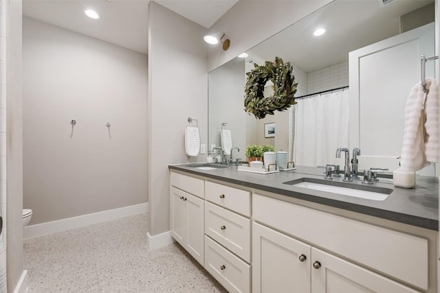 bathroom featuring vanity and toilet