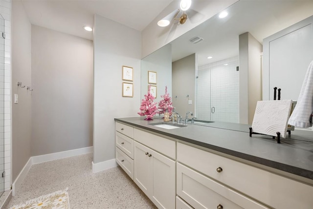 bathroom with vanity and a shower with shower door