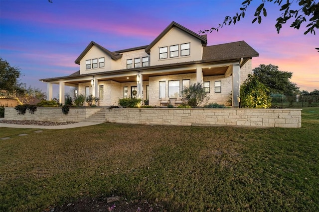 view of front of home featuring a porch and a yard