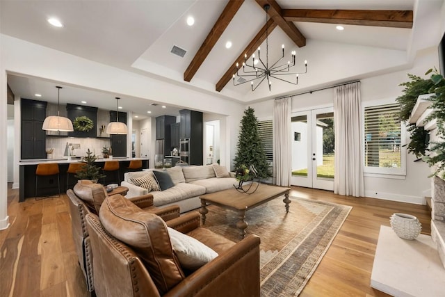 living room featuring beam ceiling, french doors, light hardwood / wood-style floors, and a notable chandelier