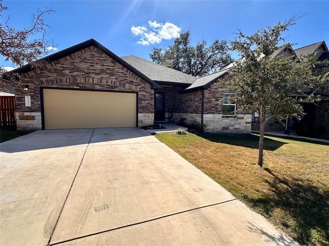 view of front of property with a front yard and a garage