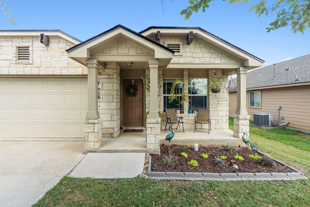 view of front of home with covered porch, a front yard, a garage, and central air condition unit