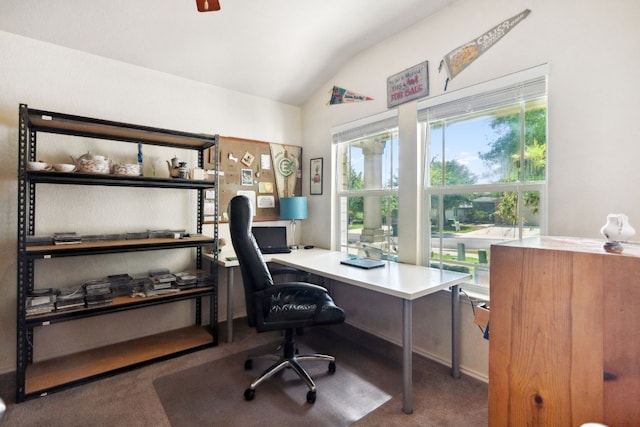 carpeted office featuring lofted ceiling