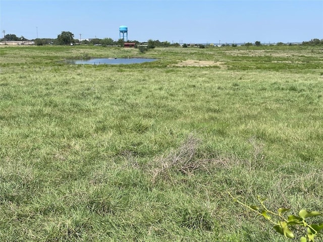 view of yard with a rural view and a water view