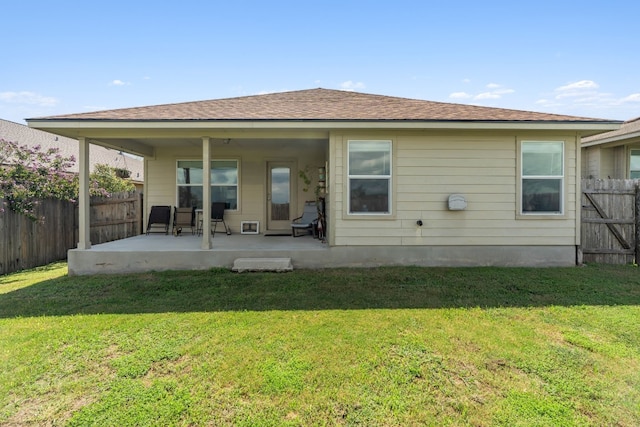 rear view of house with a yard and a patio