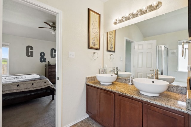 bathroom with ceiling fan, vanity, and a shower with shower door