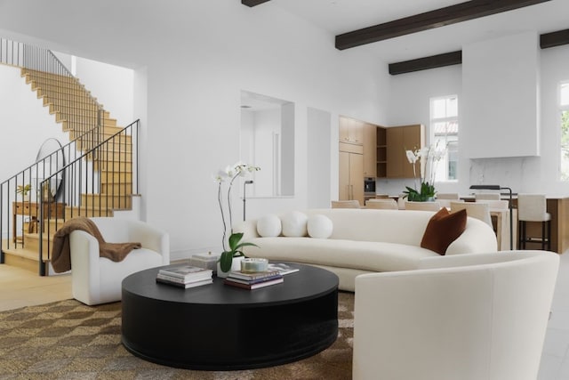 living room featuring beamed ceiling and wood-type flooring