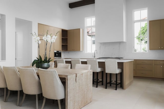 kitchen featuring a center island, a kitchen breakfast bar, and a healthy amount of sunlight