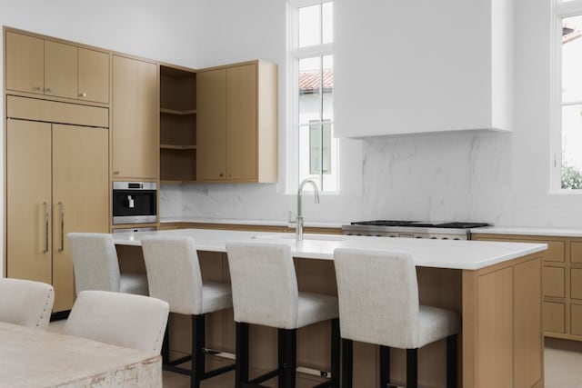 kitchen featuring plenty of natural light and an island with sink