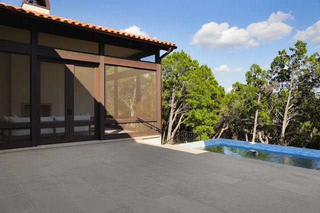 view of patio with a sunroom