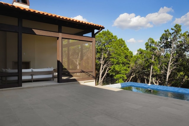 view of patio / terrace featuring an outdoor living space and a sunroom