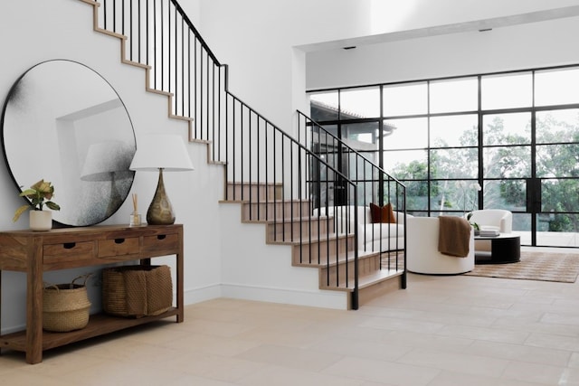 staircase featuring a towering ceiling