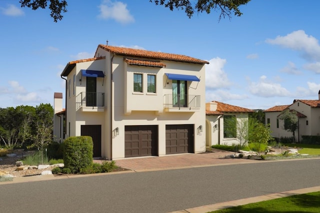 mediterranean / spanish home with a balcony and a garage